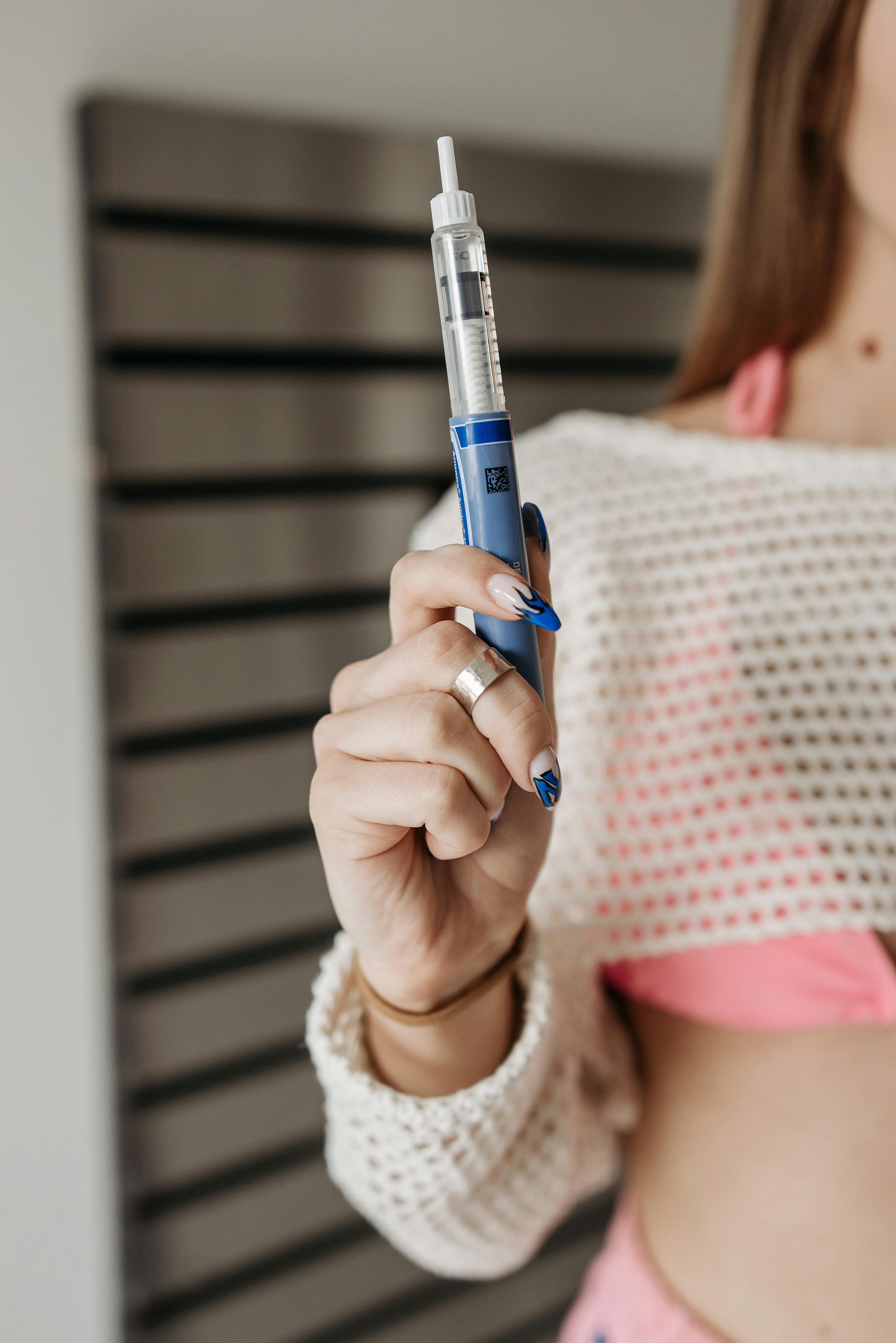 pexels-photo-7653698-7653698 Person Holding Blue and Silver Glucometer